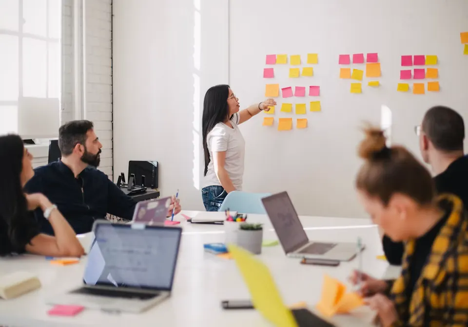 A team planning around a wall of sticky notes